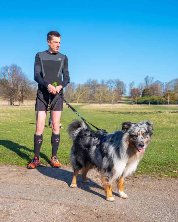 Canicrosser Robin Bennett-Fairburn and his collie on a path crossing a field