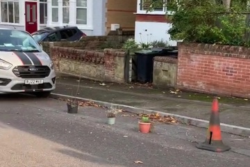 My neighbour blocks the road with cones and plant pots in selfish parking war