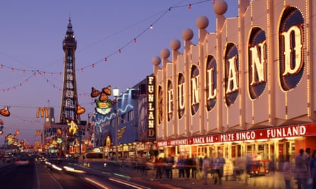 Blackpool Tower and arcades lit up at night.