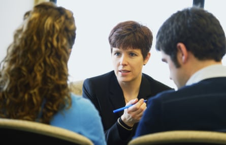 A couple in a meeting with a woman