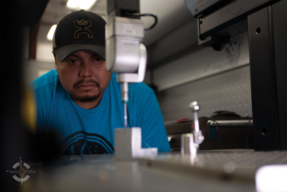 Student Aaron Sansosie operates machinery in the fabrication lab.