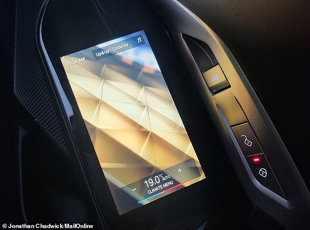 Touchscreen displays for controlling the car's features are built into the handles of both passenger doors