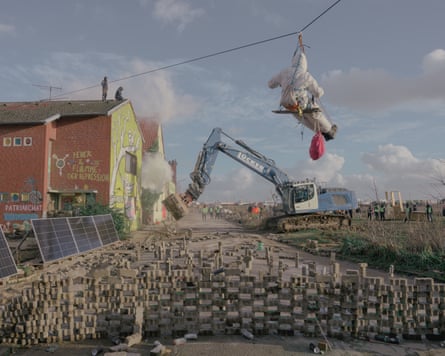 An excavator clears barricades