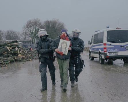 Police escort away an activist