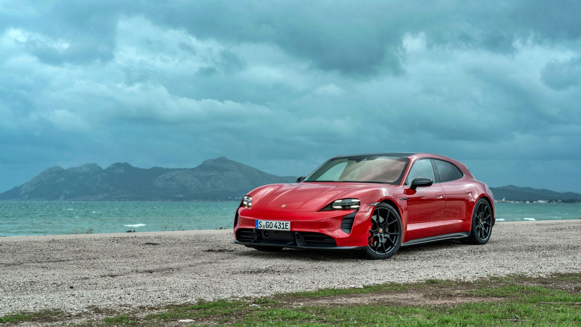 A red Porsche Taycan GTS Sport Turismo 