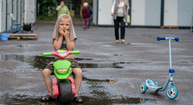 A little boy on a children's bicycle on the territory of temporary shelters in Lviv, Ukraine.