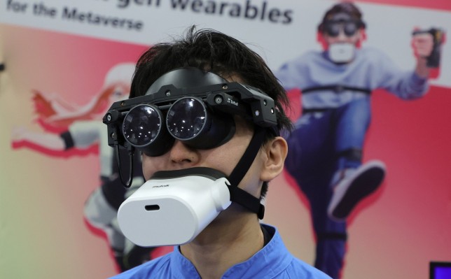 Tomohiko Fukaya demonstrates Shiftall's MeganeX headset and MuTalk