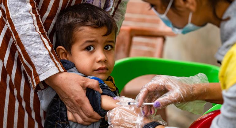 A child received a vaccine from a Department of Health worker in Ghwairan neighbouhood, Hasakeh city, northeast Syria, on 26 Oct 2022.