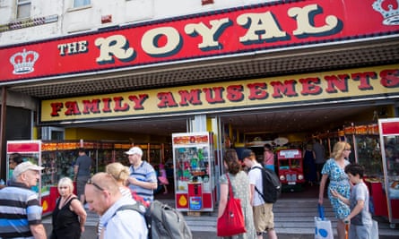 revellers pass an amuesement arcade in Margate