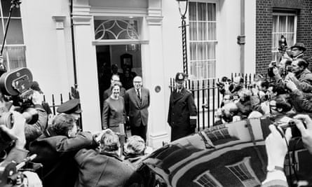 Roy Jenkins and his wife smiling for the photographers surrounding them at the door to No 11