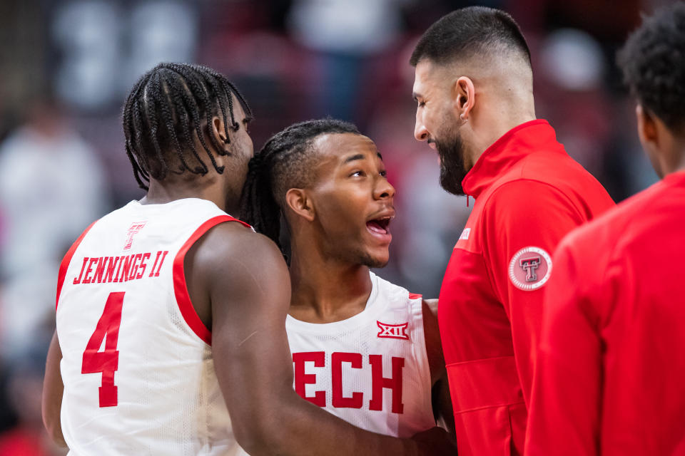 LUBBOCK, TEXAS - JANUARY 07: Guard Lamar Washington #1 of the Texas Tech Red Raiders celebrates with forward Robert Jennings #4 and Fardaws Aimaq during the second half of the college basketball game against the Oklahoma Sooners at United Supermarkets Arena on January 07, 2023 in Lubbock, Texas. (Photo by John E. Moore III/Getty Images)