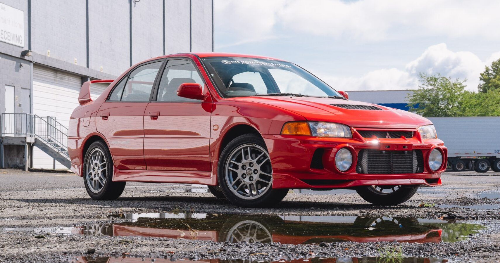 A red 1996 Mitsubishi Lancer Evolution IV GSR parked