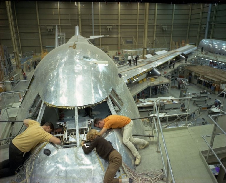 11696937 The end of the golden age of air travel: Boeing's last commercial 747 is set to be delivered today - more than 50 years after the iconic twin-aisle 'Queen of the Skies' helped change air travel forever Wiring the cockpit instruments of a Boeing 747 mockup circa 1967. The aircraft was far bigger and complex than anything Boeing had ever built before.