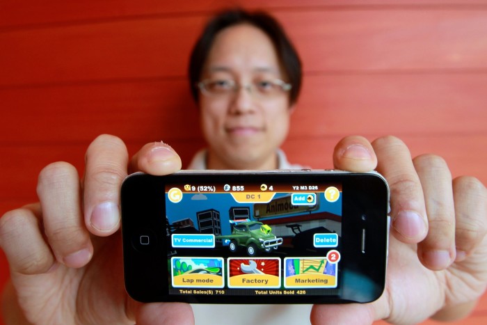 Yat Siu, as CEO of Outblaze, shows  apps on an iPhone