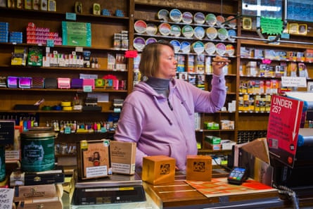 Shirley Debenham inspects a cigar.