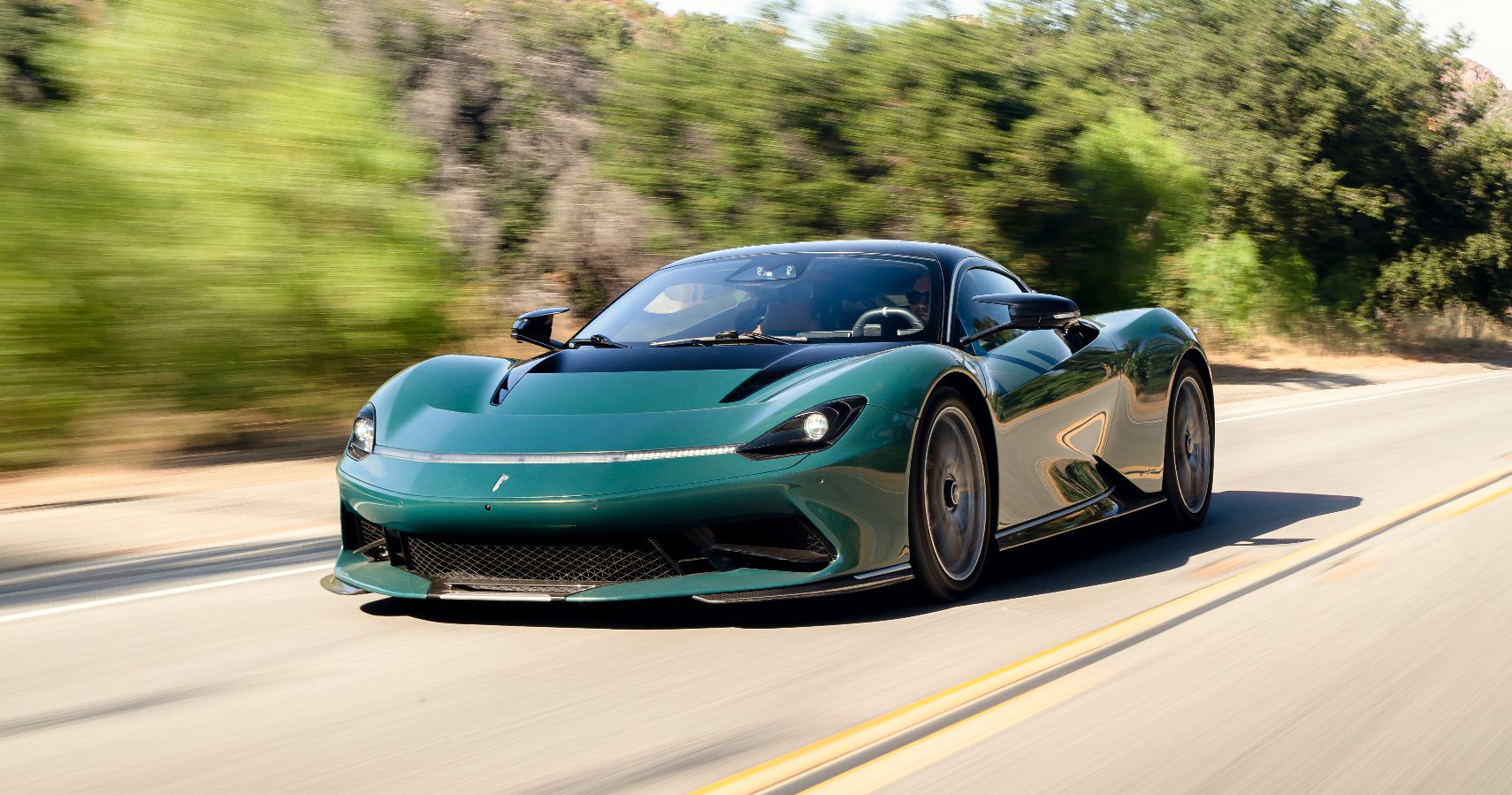 Green Pininfarina Battista electric hypercar driving 