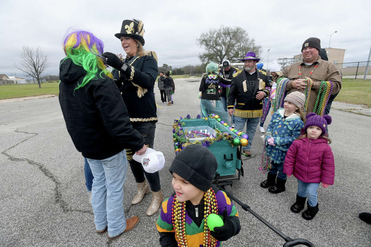Families, including a group from Krewe des Amis, get ready to join in the Munchkin Parade during Mardi Gras on the Sabine Saturday in Orange. Photo made Saturday, February 11, 2023 Kim Brent/Beaumont Enterprise