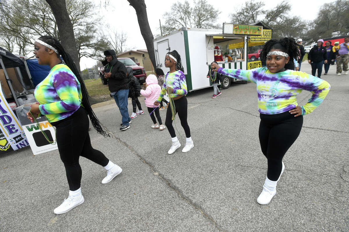 Members of the dance squad the Exquisite Diamonds join in the Munchkin Parade during Mardi Gras on the Sabine Saturday in Orange. Photo made Saturday, February 11, 2023 Kim Brent/Beaumont Enterprise