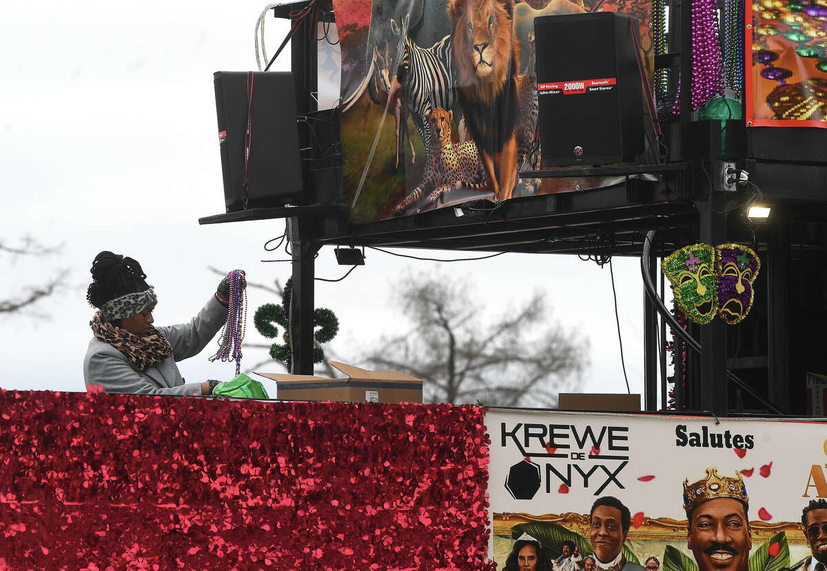 Members of Krewe de Onyx finish decorating their float for the night parade during Mardi Gras on the Sabine Saturday in Orange. Photo made Saturday, February 11, 2023 Kim Brent/Beaumont Enterprise