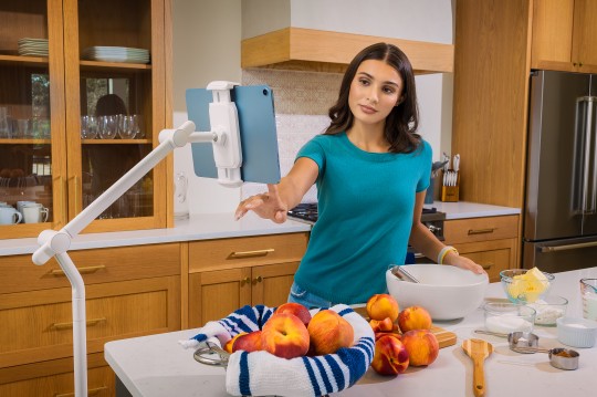 Woman using iPad stand in the kitchen