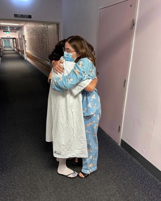 Hayton and Bryant hug before their surgeries 