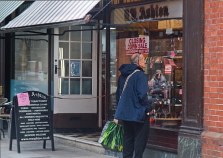 A customer peers through the window of MW Ashton’s.