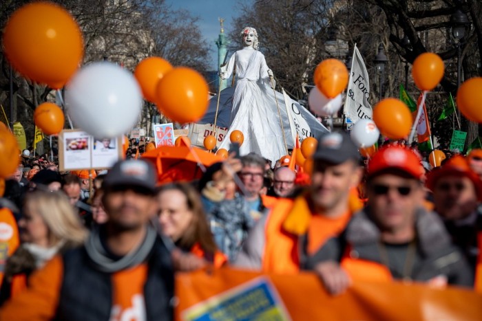 Protesters from the French Democratic Confederation of Labour march against government plans to reform  pensions, in Paris last month