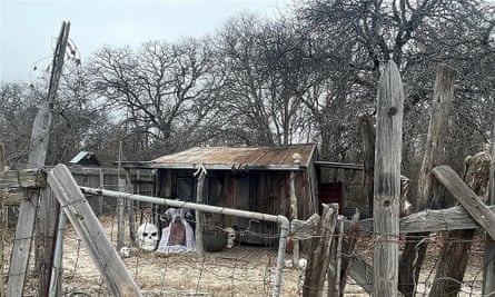 a rickety barn behind a rickety fence