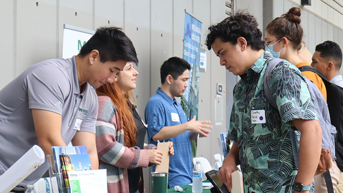 students talking to employers at career fair