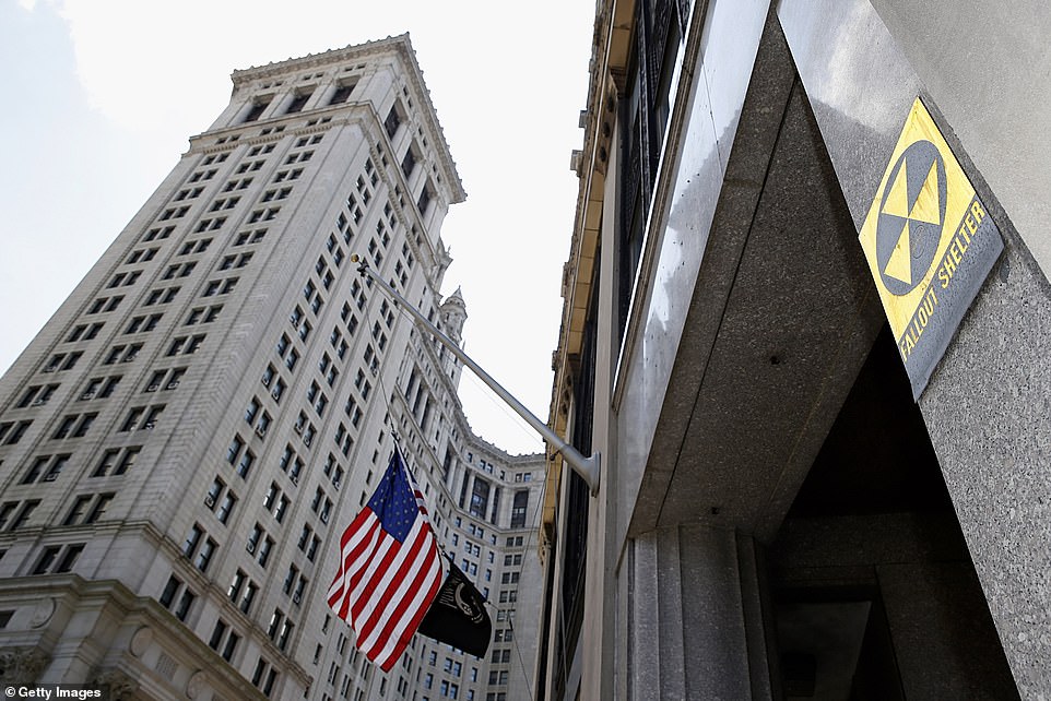 A Fallout Shelter sign and American flag next to the Manhattan Municipal Building. There are still fallout shelters scattered across New York City from the fraught Cold War era. Not all are fully operational, but may provide shelter and respite if the city was ever attacked with nuclear warfare