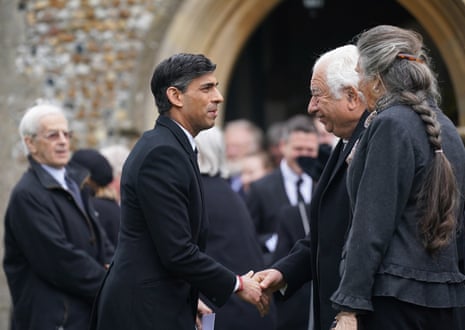 Rishi Sunak speaking to other mourners at the funeral.