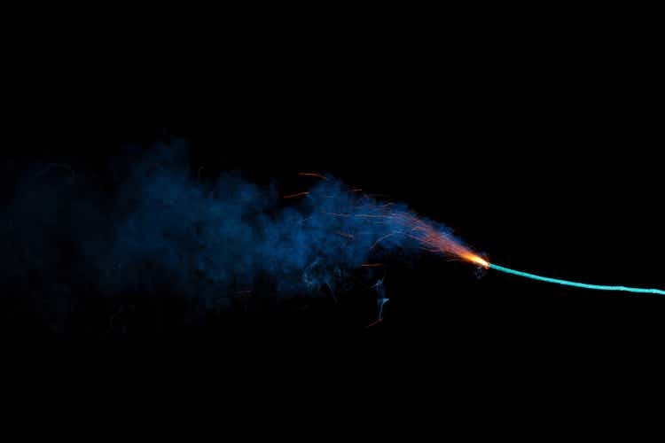 Burning fuse with sparks and blue smoke isolated on black background