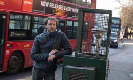 Oliver Lord, head of strategy for the Clean Cities campaign, beside an air-quality monitor in Kingston upon Thames.