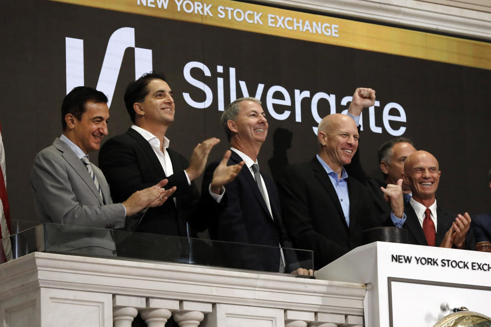 Slivergate CEO Alan Lane, second from right, is applauded as he rings the New York Stock Exchange opening bell before his bank&#39;s IPO begins trading, Thursday, Nov. 7, 2019. (AP Photo/Richard Drew)