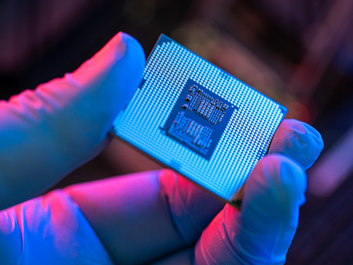 Close-up of person holding computer chip