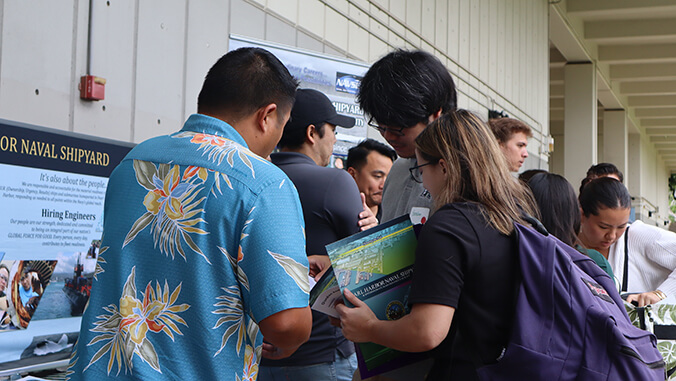 students talking to employers at career fair