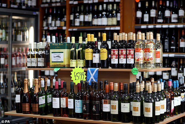 New research suggests 156 deaths per year on average in Scotland may have been prevented due to the price change. Pictured: Alcohol for sale in an Edinburgh off-licence