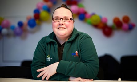 Portrait of Chelsea Tierney smiling for the camera in a green Morrisons uniform fleece