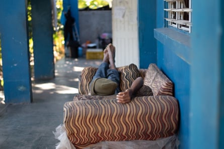 Man lying on a sofa in Open Arms homeless shelter, Kingston Jamaica