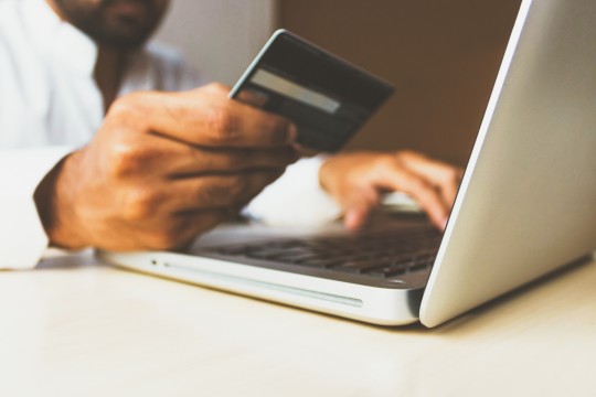 Man on laptop with credit card