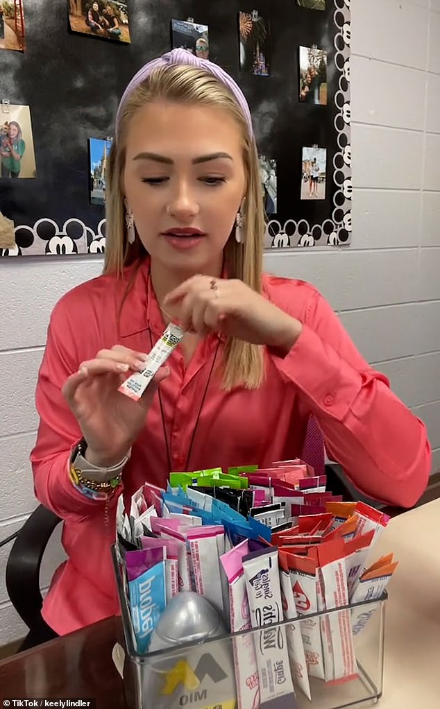 Influencers are sharing clips detailing their 'water of the day' recipes — which involve a concoction of aspartame-filled powders and syrups (Pictured is a tub full of powder sachets)