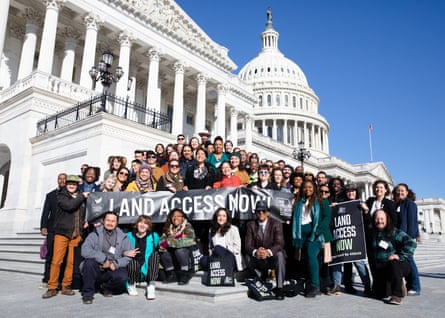 group of people with sign saying ‘land access now’ at US Capitol.