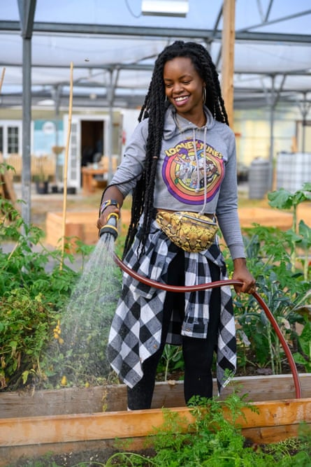 Nyema Clark watering plants