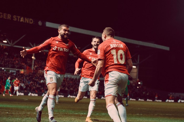 Wrexham striker Paul Mullin celebrates with team mates after scoring 