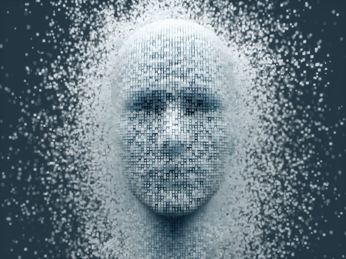 Human face emerges from machine-like pixels.