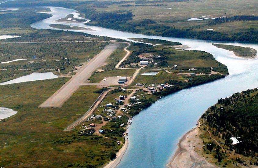 An aerial view of a village on a river