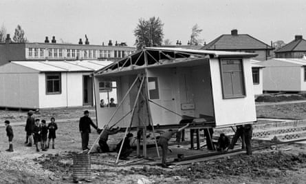 Schoolchildren help labourers construct a new estate of pre-fabricated houses in Watford, Hertfordshire.