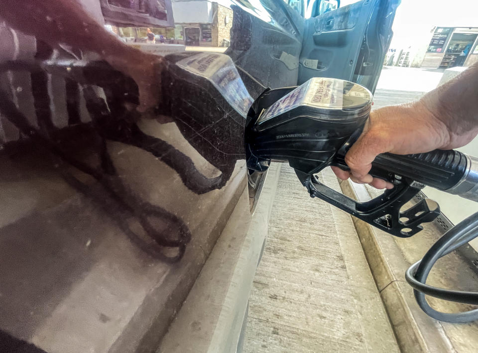 PENZANCE, UNITED KINGDOM - AUGUST 12: A man holds a fuel pump nozzle as he refuels a van with diesel at a fuel station at a branch of the supermarket retailer Sainsbury&#39;s on August 12, 2022 in Penzance, England. The British retailer, founded in 1869, is one of the largest market leaders of groceries in the UK. (Photo by Matt Cardy/Getty Images)