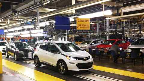 Workers assemble Chevy Bolt cars at a GM plant