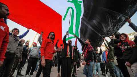 Protesters wave a giant Iraqi flag in Baghdad